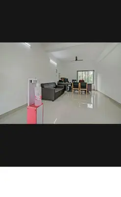 a large living room with a couch and a table at Subramania Arcade in Trichūr