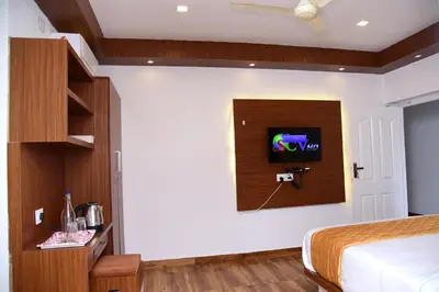 a bedroom with a bed and a tv on the wall at NIRVANA HOLISTIC LIVING in Varagampadi