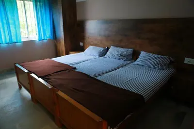 a bedroom with a large bed with a wooden headboard at Chakalakkal Residency in Sultan Bathery
