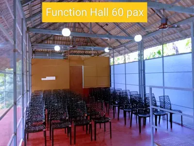 a room with a bunch of chairs and tables at Forest and River Edge Resort in Kannur