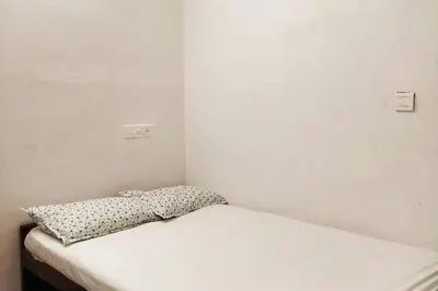 a white bed with a pillow on top of it at Forestay -3 BHK Villa Kochi in Pallipuram
