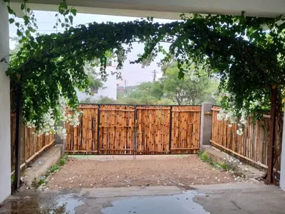 an entrance to a wooden fence with a gate at SHI's Triveni Spacious 2BHK Villa in Pappampatti, Coimbatore in Coimbatore