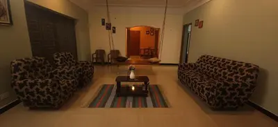 a living room with two couches and a coffee table at SHI's Triveni Spacious 2BHK Villa in Pappampatti, Coimbatore in Coimbatore