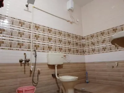 a bathroom with a toilet and a shower at SHI's Triveni Spacious 2BHK Villa in Pappampatti, Coimbatore in Coimbatore