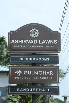 a sign for a hotel and convention center at Ashirvad Lawns Hotel & Convention Centre in Kozhikode