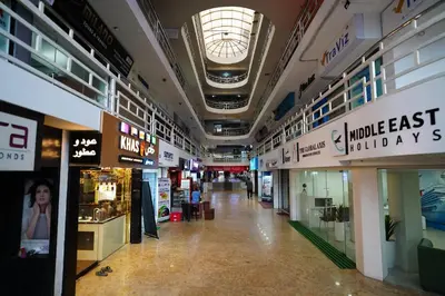 a hallway in a shopping mall with many shops at Emarald Hotel Calicut in Kozhikode