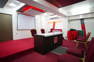a meeting room with chairs and a white board at Emarald Hotel Calicut in Kozhikode