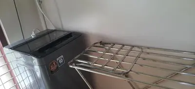 a trash can sitting next to a metal rack at NEST Mdy in Mananthavady