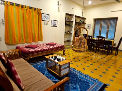 a living room with a couch and a chess board at A Chettinad villa in Coimbatore on the way to Adiyogi and nearer to Maruthamalai in Coimbatore