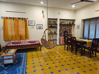 a living room with a couch and a table at A Chettinad villa in Coimbatore on the way to Adiyogi and nearer to Maruthamalai in Coimbatore