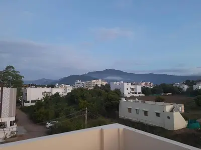a view of a city from the roof of a building at A Chettinad villa in Coimbatore on the way to Adiyogi and nearer to Maruthamalai in Coimbatore