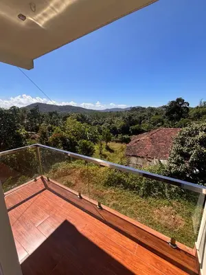 a balcony with a view of the mountains at Empra Exotica in Madikeri