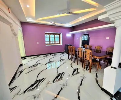 a dining room with a marble floor and purple walls at Coimbatore Premium Private Villa a FAMILY RESORT kids, celebration hall in Coimbatore
