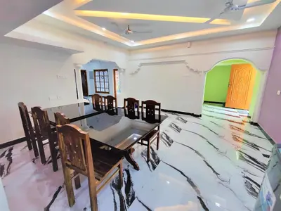 a dining room with a table and chairs at Coimbatore Premium Private Villa a FAMILY RESORT kids, celebration hall in Coimbatore