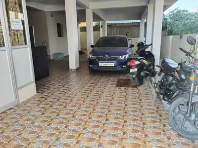 a motorcycle and a car parked in a garage at Varun residency in Coimbatore
