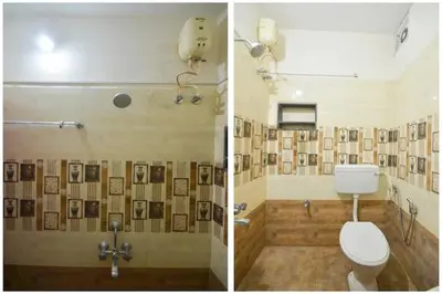 a bathroom with a toilet and pictures on the wall at Varun residency in Coimbatore
