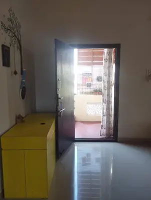 a room with a yellow door and a window at SHI's Bhairavi Peaceful 2bhk villa - - On the way 2 isha-Adiyogi , Maruthamalai in Coimbatore