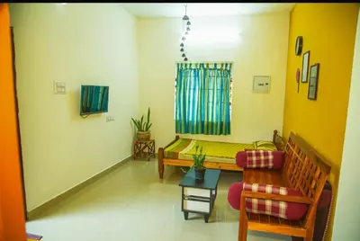 a living room with a bench and a chair at SHI's Bhairavi Peaceful 2bhk villa - - On the way 2 isha-Adiyogi , Maruthamalai in Coimbatore