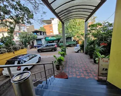 an outdoor stairway with cars parked on a street at Hotel Mothimahal in Trichūr