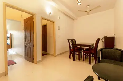 a dining room with a table and chairs at Karapuzha Village Resort in Wayanad