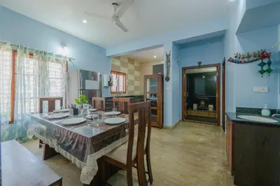 a dining room with a table and some chairs at LikeMyVilla 3bedroom villa in Vānivilāsa Puram