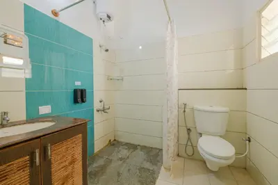 a bathroom with a toilet and a sink at LikeMyVilla 3bedroom villa in Vānivilāsa Puram