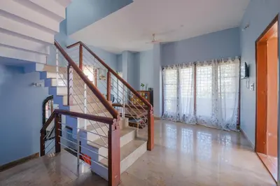 a staircase in a room with blue walls at LikeMyVilla 3bedroom villa in Vānivilāsa Puram