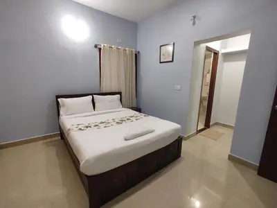a bedroom with a large bed in a room at LikeMyVilla 3bedroom villa in Vānivilāsa Puram