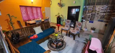 an overhead view of a living room with a blue couch and chairs at JJ's White House in Trichūr