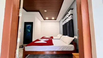 a bedroom with a bed with a red blanket at Cave Valley Wayanad in Ambalavayal