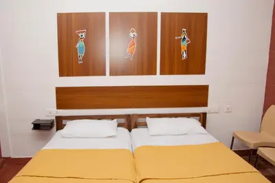 two beds in a room with wooden headboards at Deepwoods Stay-Kinathukadavu, Coimbatore in Coimbatore