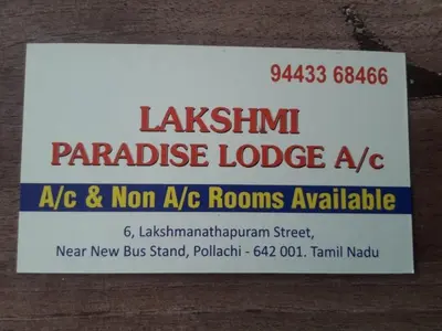 a sign on the side of a building at Lakshmi Paradise Lodge A/C in Pollāchi