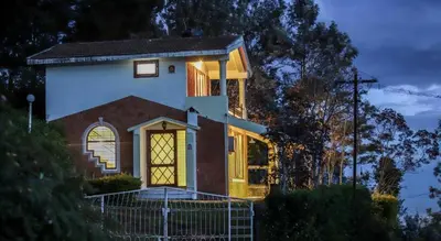 a house is lit up at night at The Orange Home in Kotagiri