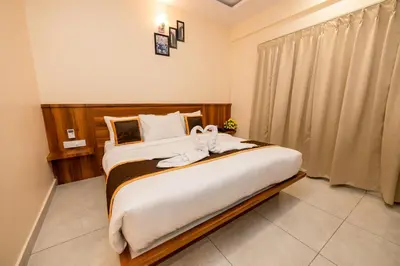 a bedroom with a large bed with towels on it at KK Comforts in Shrīrangapattana