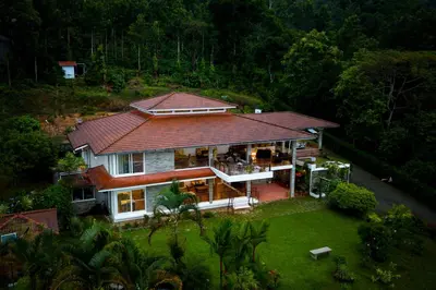 an aerial view of a house with a roof at ama Stays & Trails Arcadia, Coorg in Madikeri