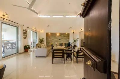 a living room with a table and a dining room at ama Stays & Trails Arcadia, Coorg in Madikeri