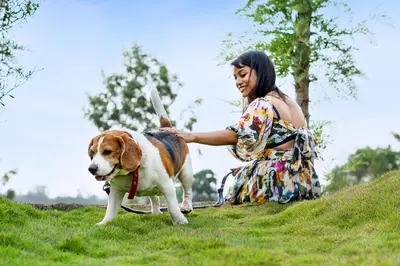 a woman with a dog on a leash at Hatti Eden Coorg in Gonikoppal