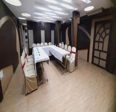 a conference room with a white table and chairs at NavaRATNA Delight in Coimbatore