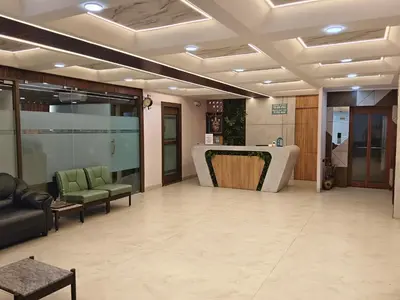 a lobby with chairs and a table in a building at NavaRATNA Delight in Coimbatore