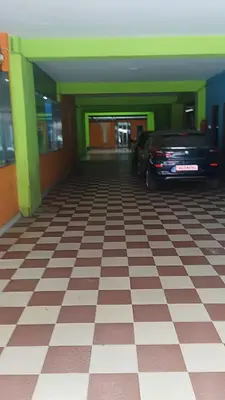 a car parked in a room with a checkered floor at PPH Living TriColours Hotel Gandhipuram in Coimbatore