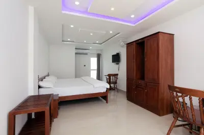 a bedroom with a bed and a table and chairs at Mscb guest house in Idukki