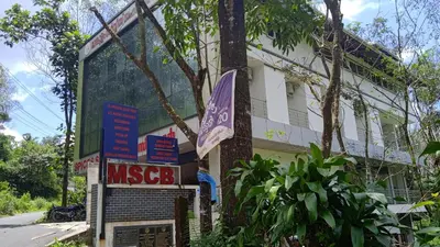 a building with a sign in front of it at Mscb guest house in Idukki