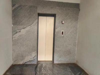 a white door in a room with a wall at Suyog Apartments in Mysore
