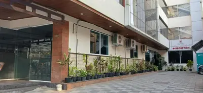a building with potted plants outside of it at HOTEL PANKAJ RESIDENCY in Guruvāyūr
