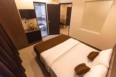 a hotel room with two beds and a bathroom at HOTEL PANKAJ RESIDENCY in Guruvāyūr