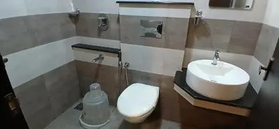 a bathroom with a toilet and a sink at HOTEL PANKAJ RESIDENCY in Guruvāyūr