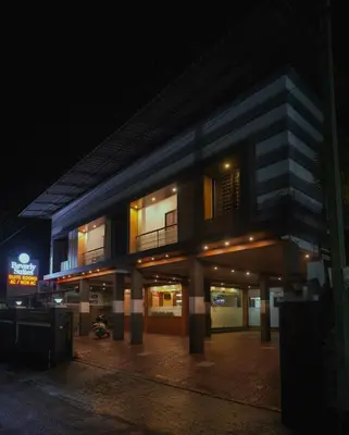 a building at night with its lights on at BEVERLY SUITES in Wayanad