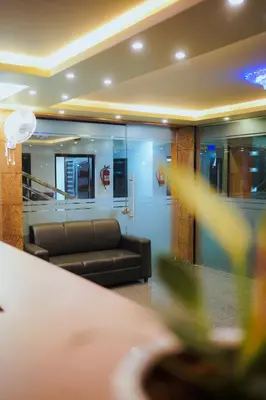 a waiting room with a couch and a table at BEVERLY SUITES in Wayanad