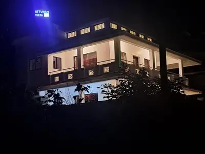 a building at night with a light up sign on it at ATTUVAM VISTA in Kodaikānāl