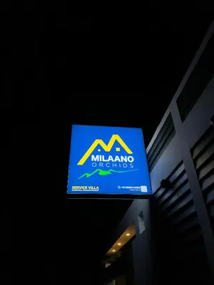 a sign for a milling outyards sign on a building at Milaano Orchids, Service Villa, Kammana Mananthavady in Wayanad
